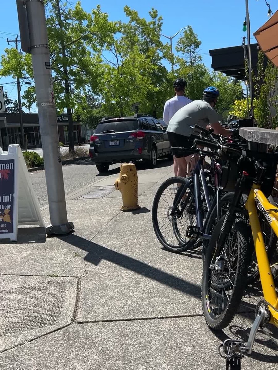 Cyclists locking up their bikes outside Burke-Gilman Brewing